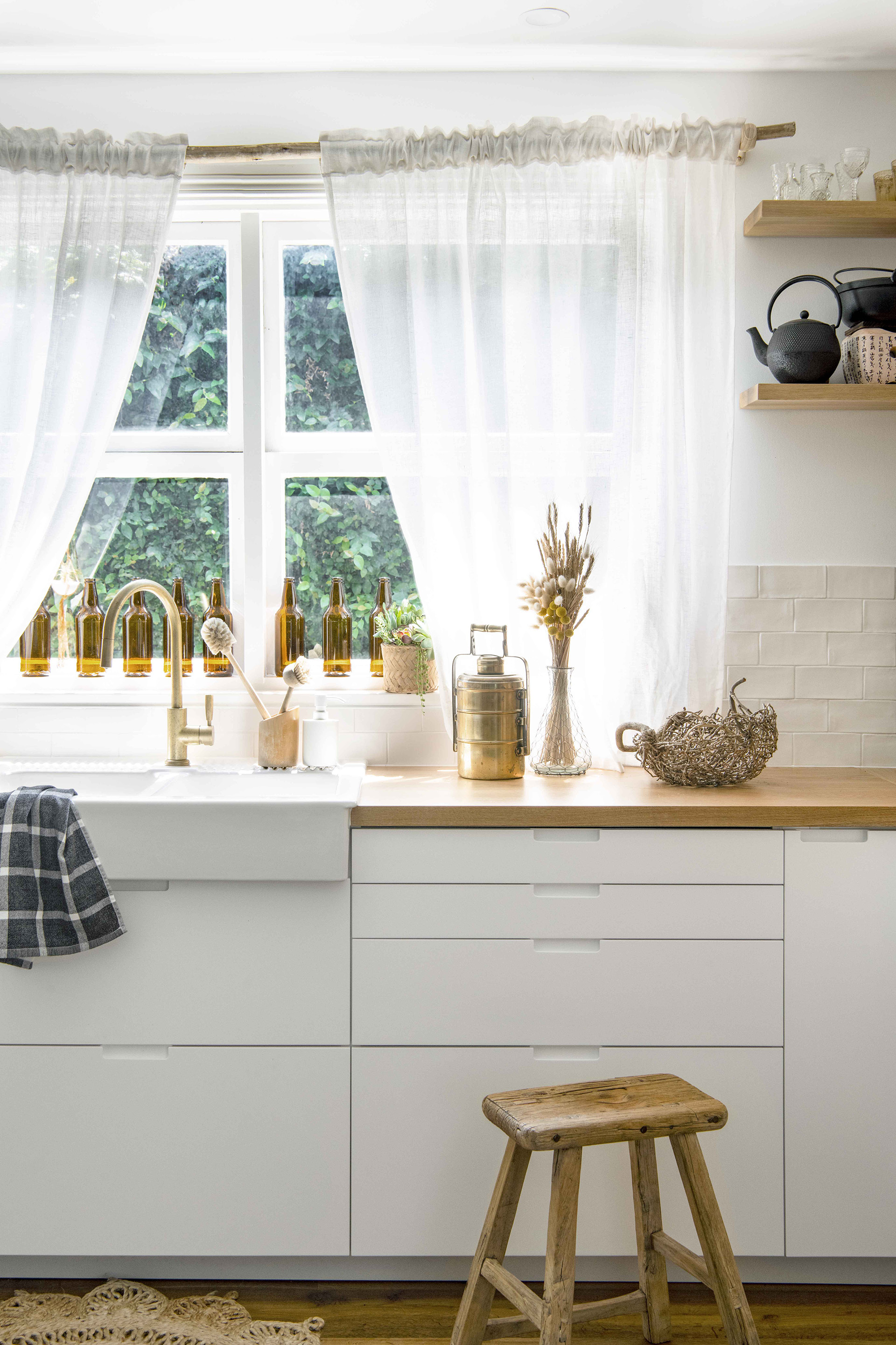 White and timber country style kitchen with farmhouse sink.