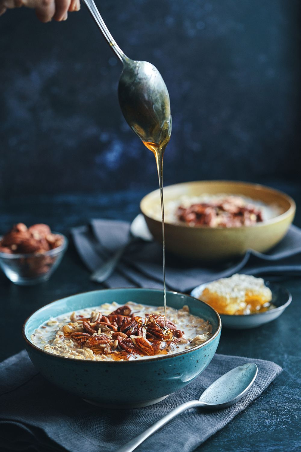 Bowl of porridge being drizzled with honey