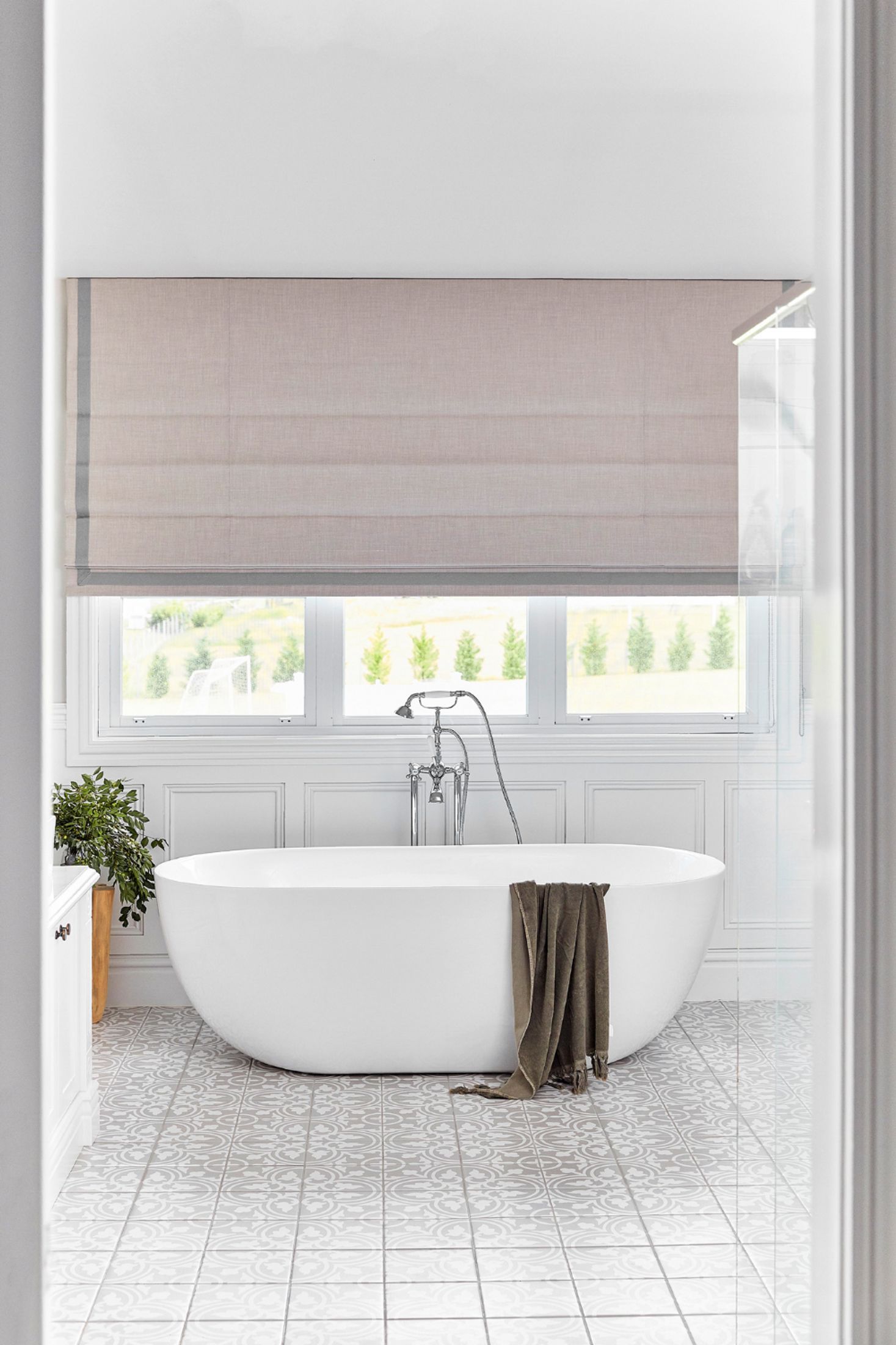 Large bathroom with a freestanding bath, Victorian bath filler and wainscoting