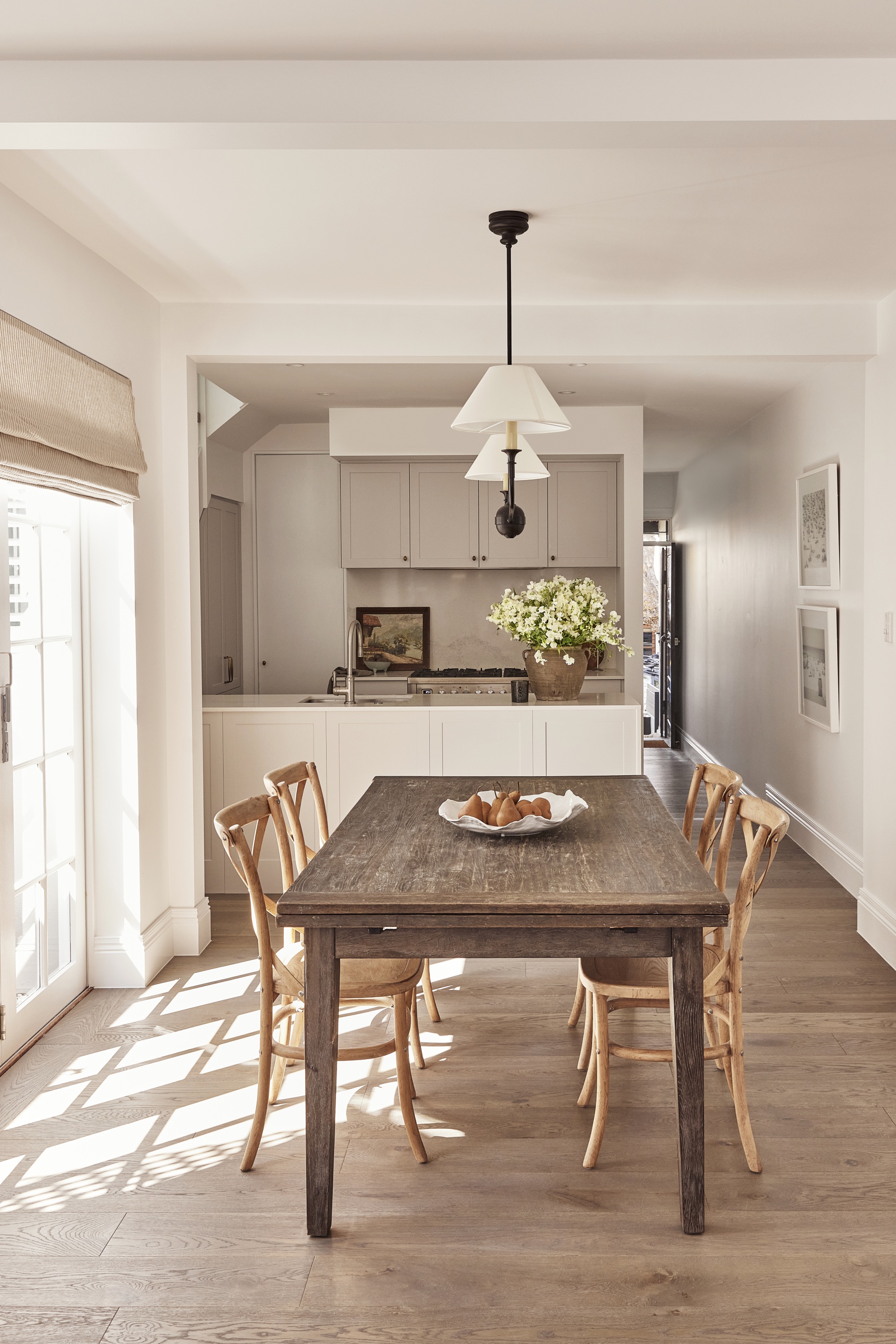 A neutral coloured dining area leading to the kitchen.