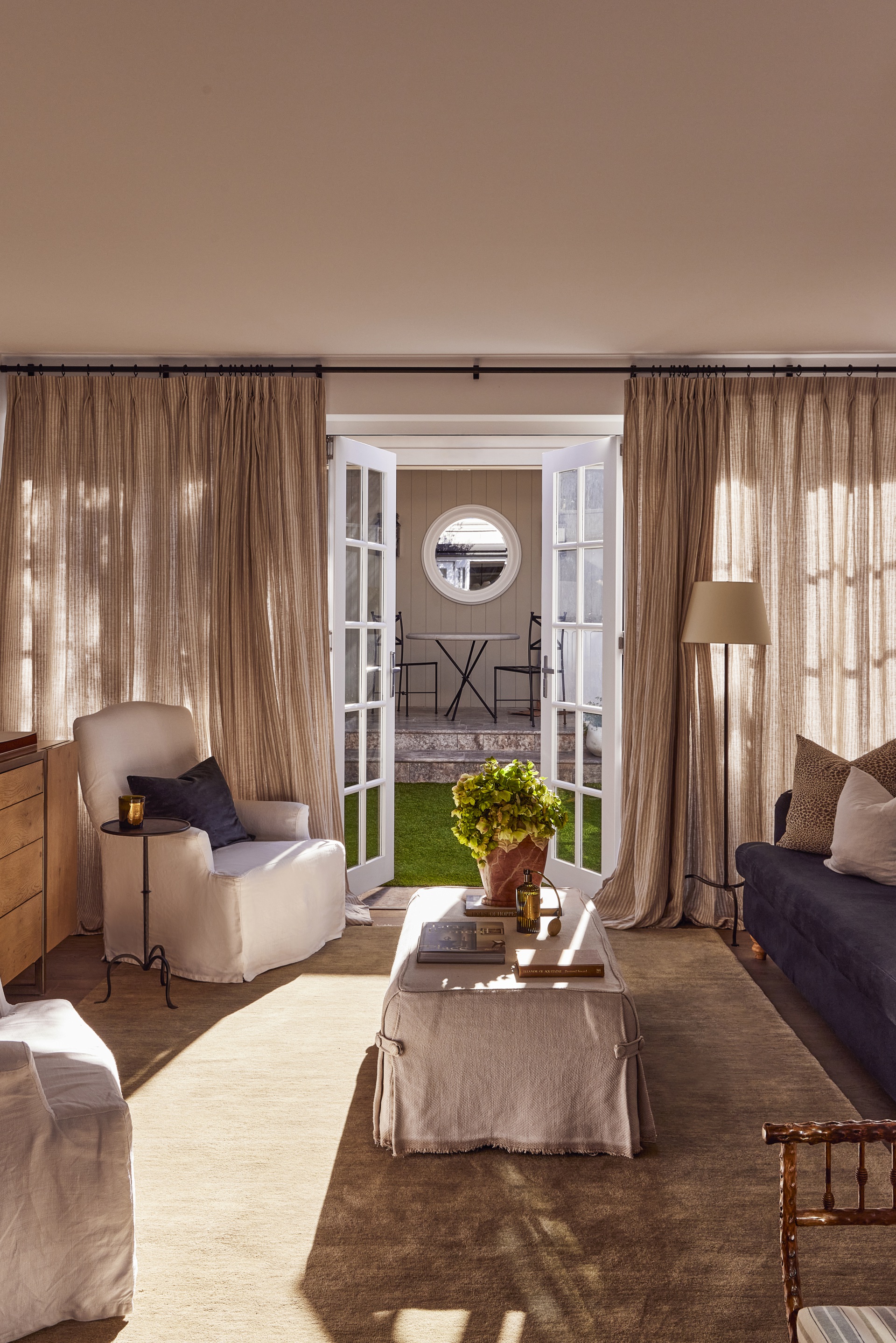 Floor to ceiling curtains frame the contemporary living area opening to the backyard.