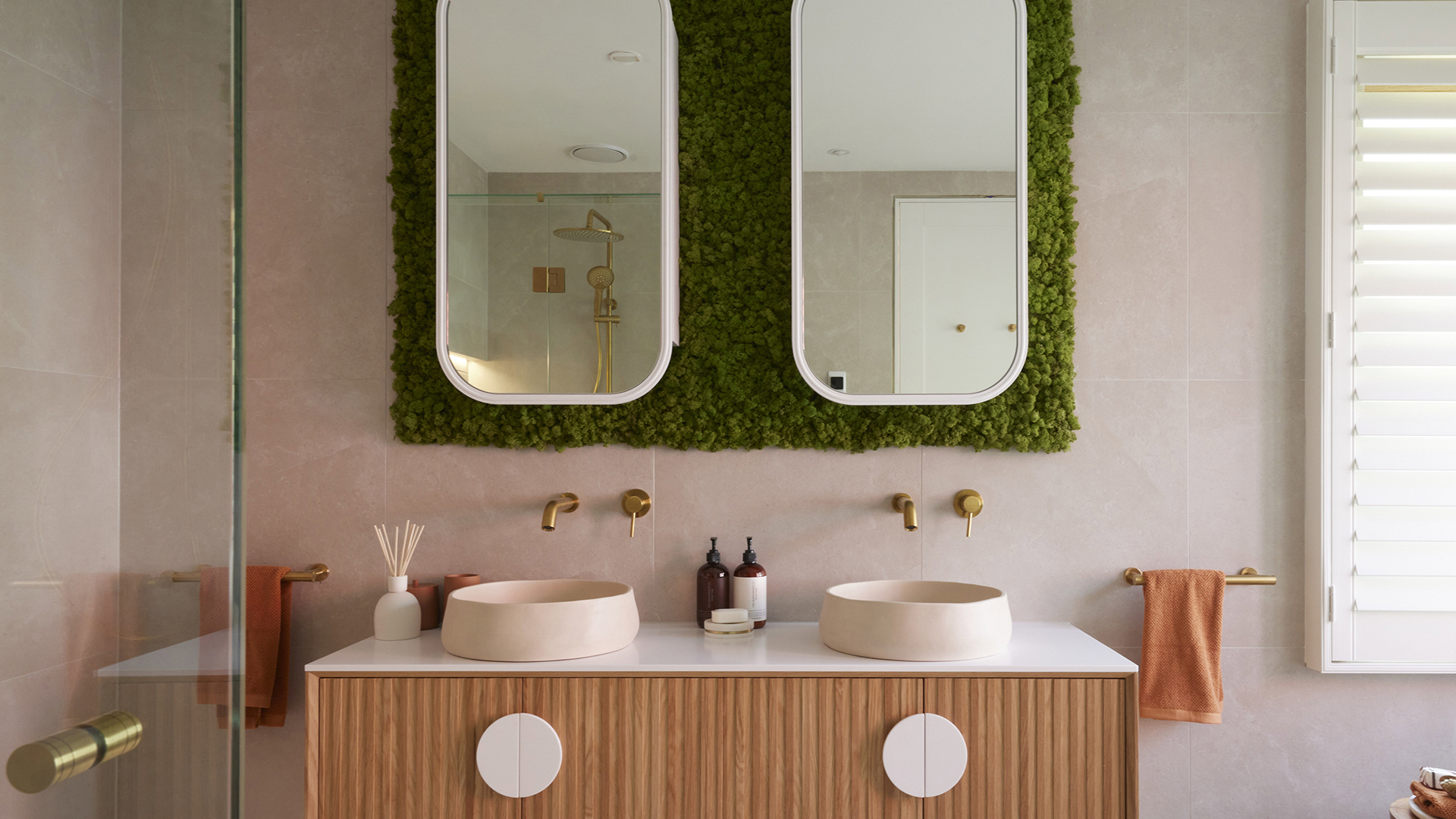 Contemporary bathroom with moss feature wall above vanity.