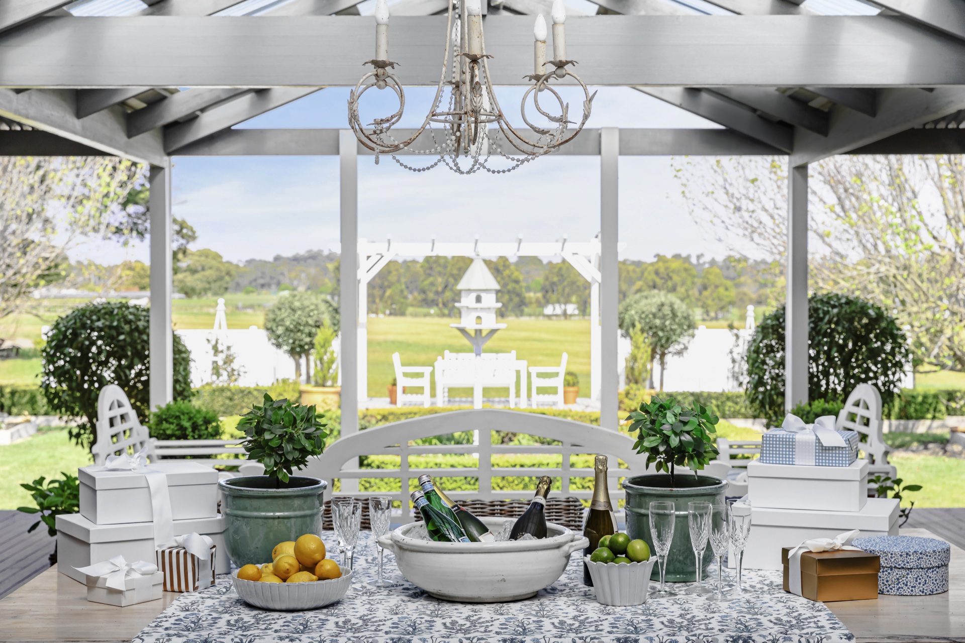 The outdoor alfresco dining area with a classic blue and white table setting.