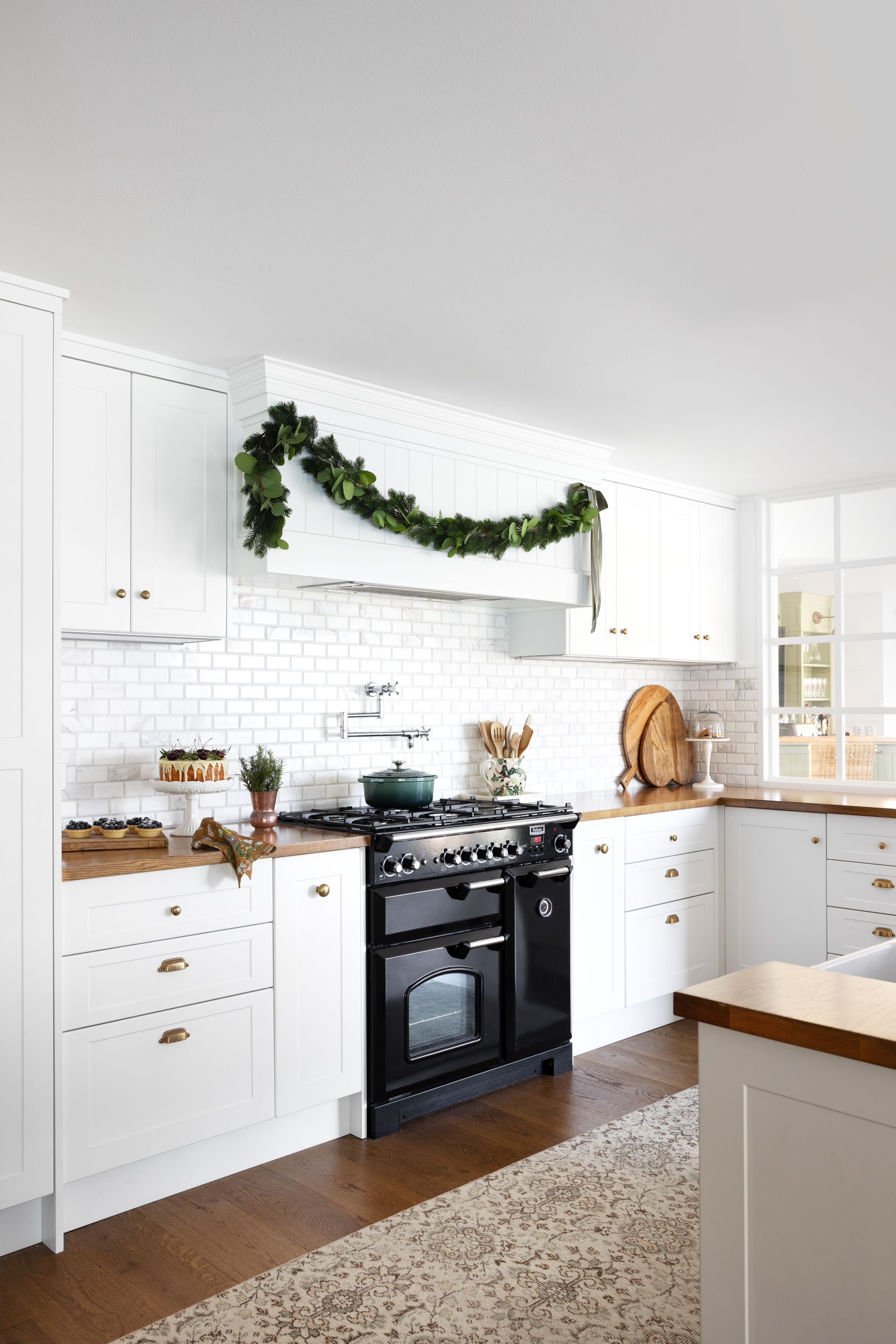 A classic all-white kitchen with oak benchtops.