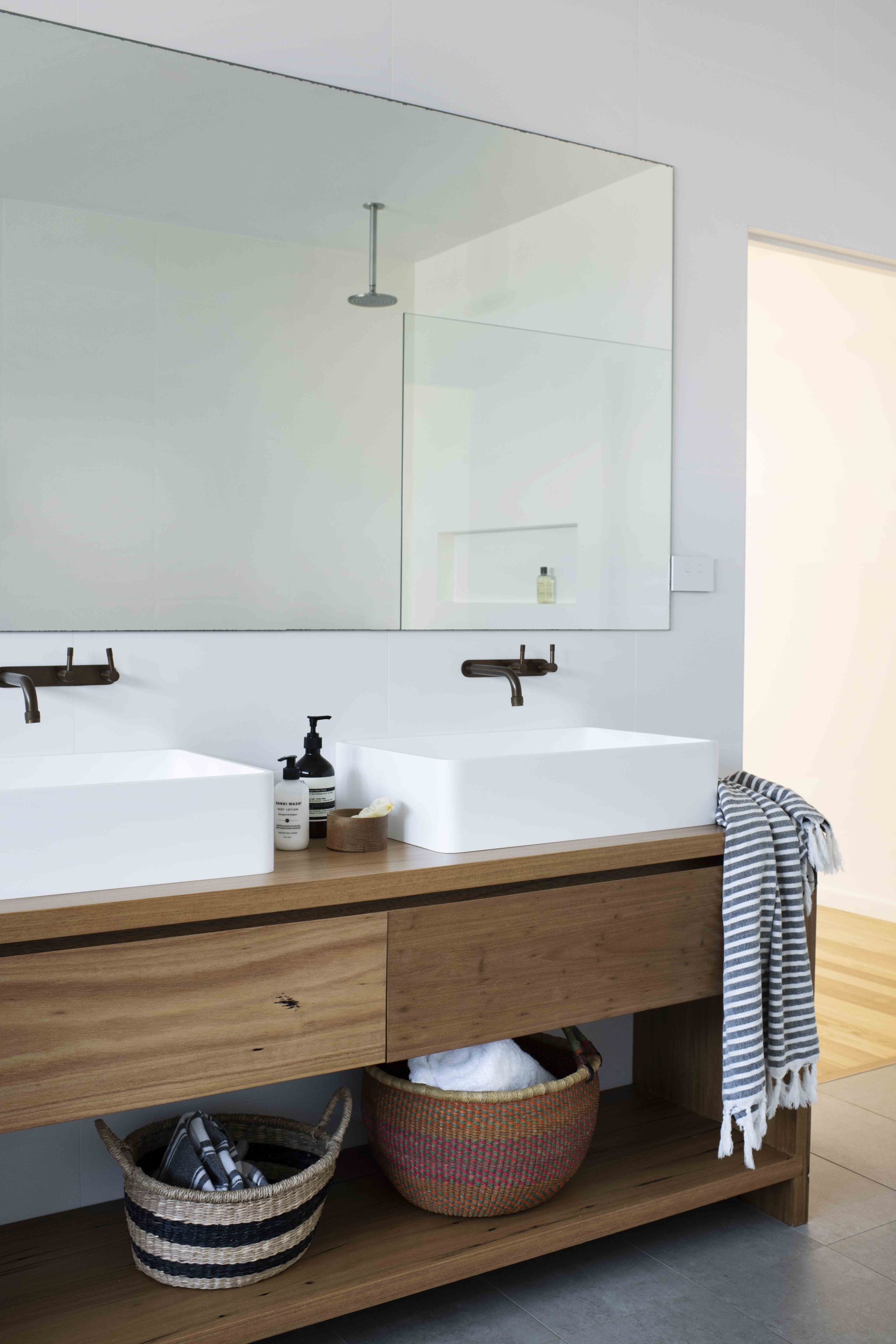 Bathroom with timber vanity and storage.