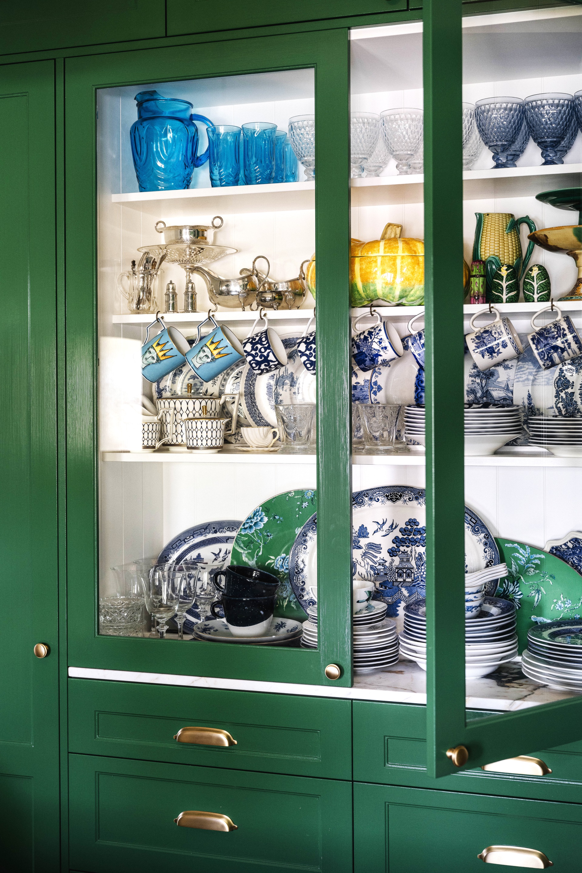 An open green china cabinet.