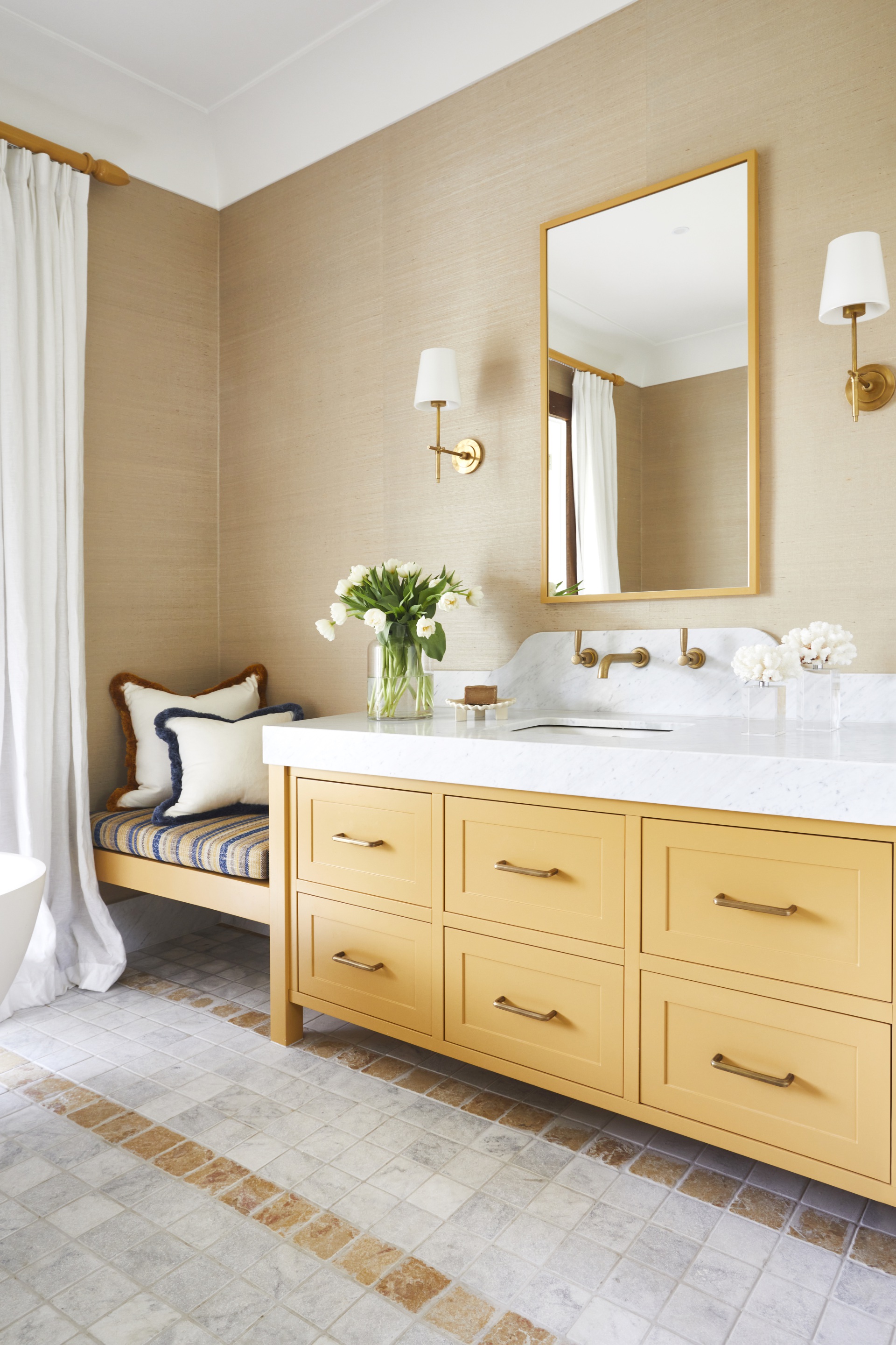 A large ochre vanity and bench in an ensuite.