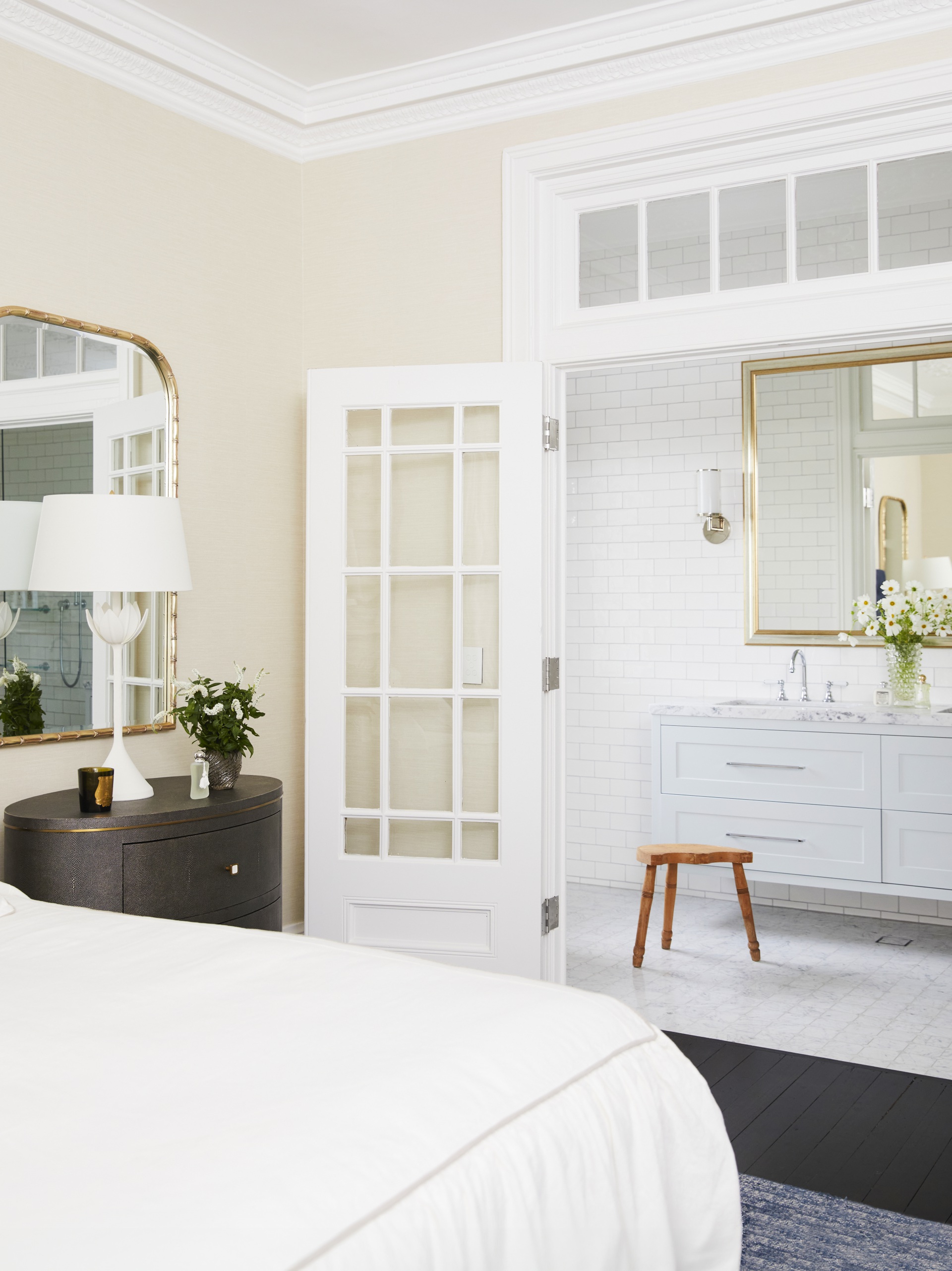 A classic white main bedroom and ensuite with French-style doors.