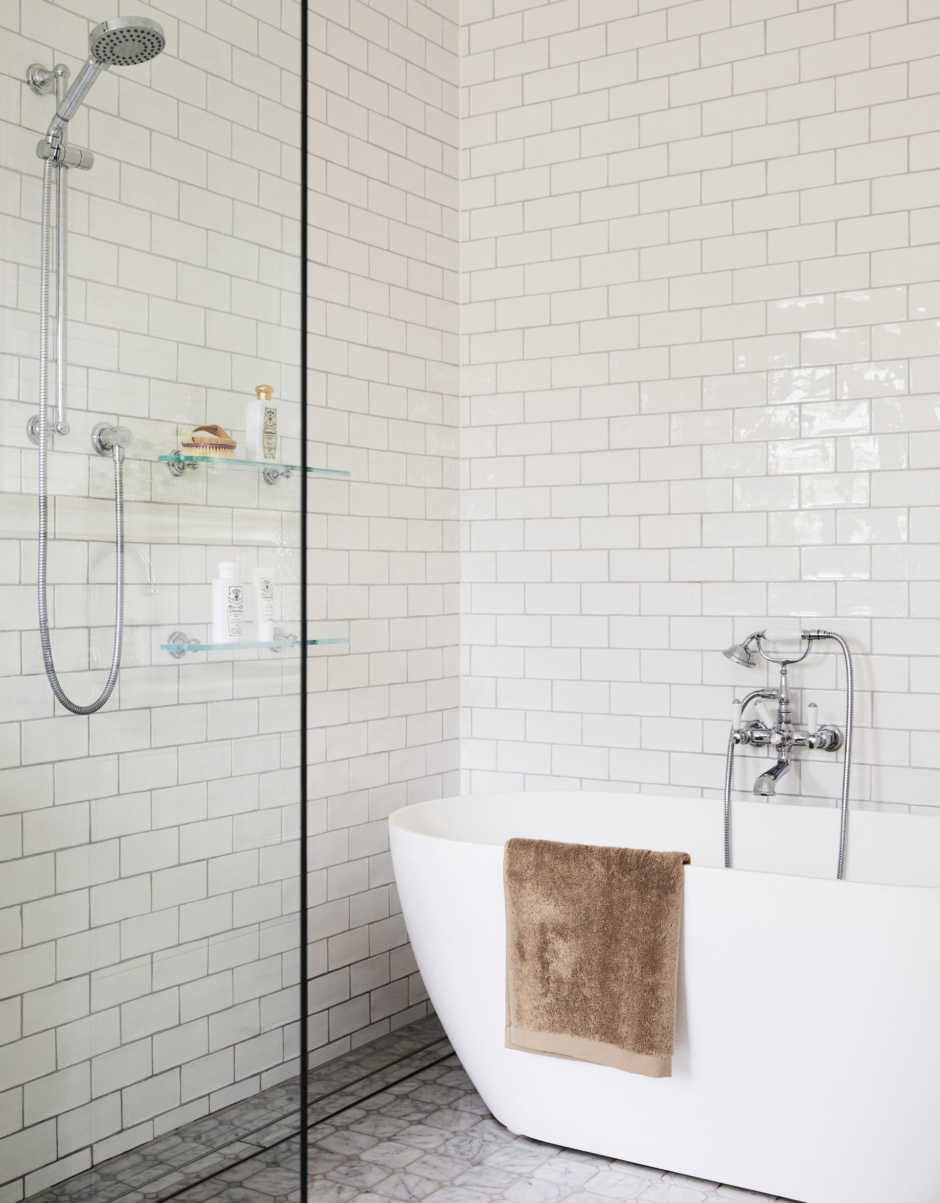 A classic white ensuite with a freestanding bath.