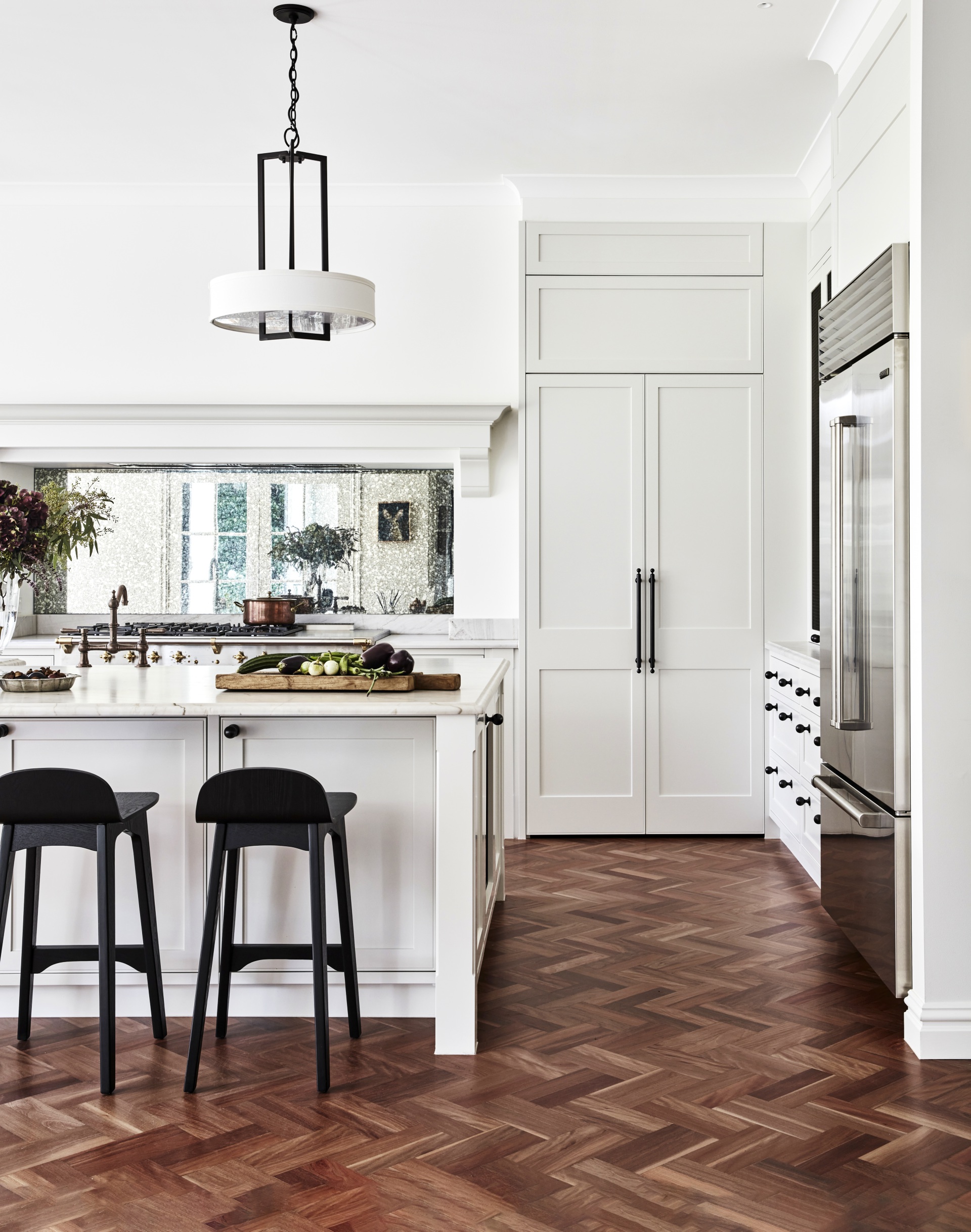 A classic country kitchen with shaker-style cabinets and parquet flooring.