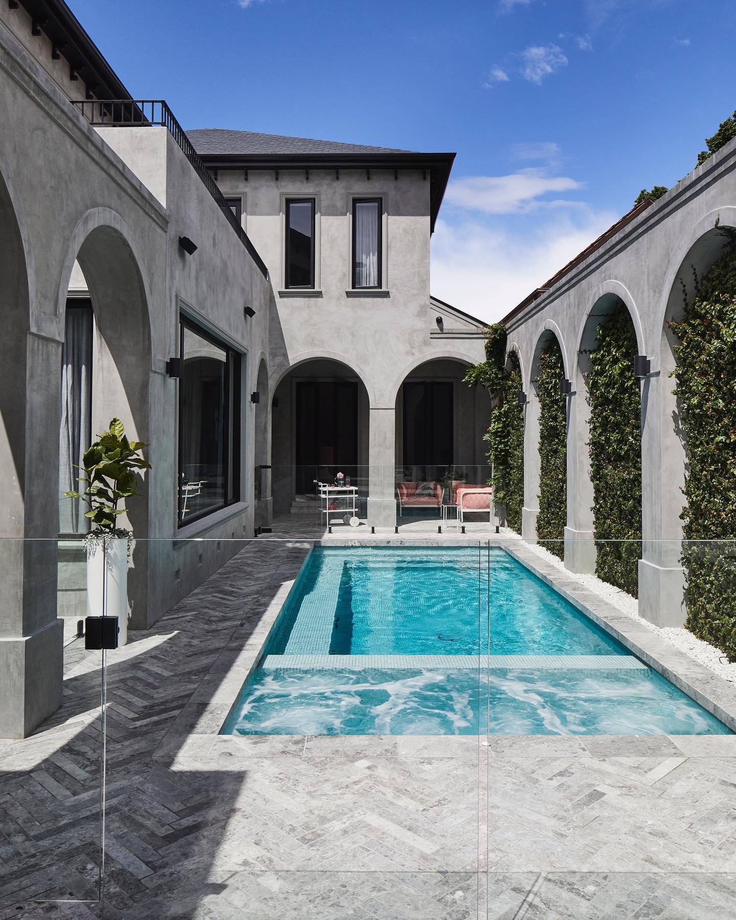 The pool in Bec Judd's courtyard is surrounded by arches that lead to an alfresco living area.