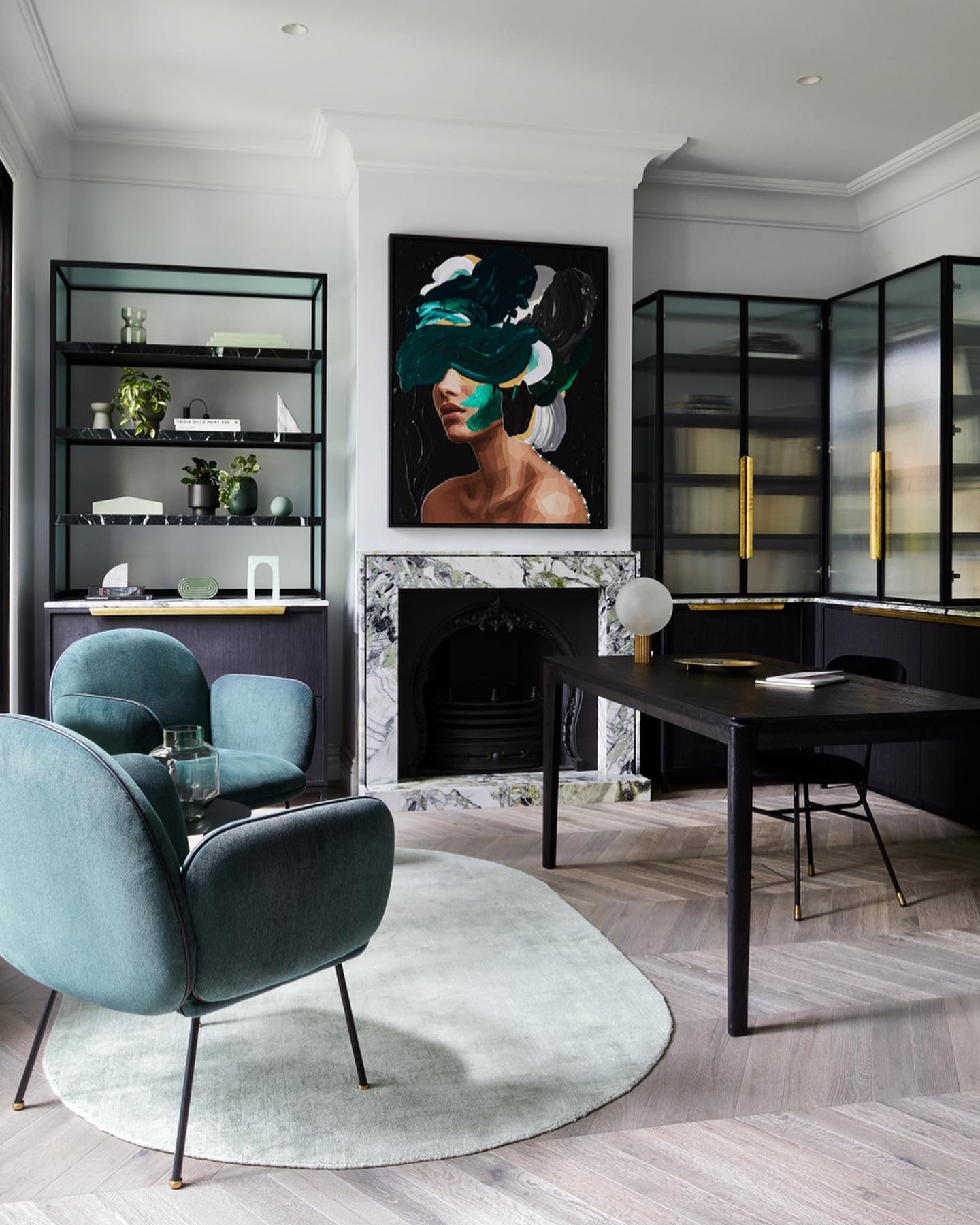 Bec Judd's study has marble shelving and a marble fireplace with a large painting above it. 