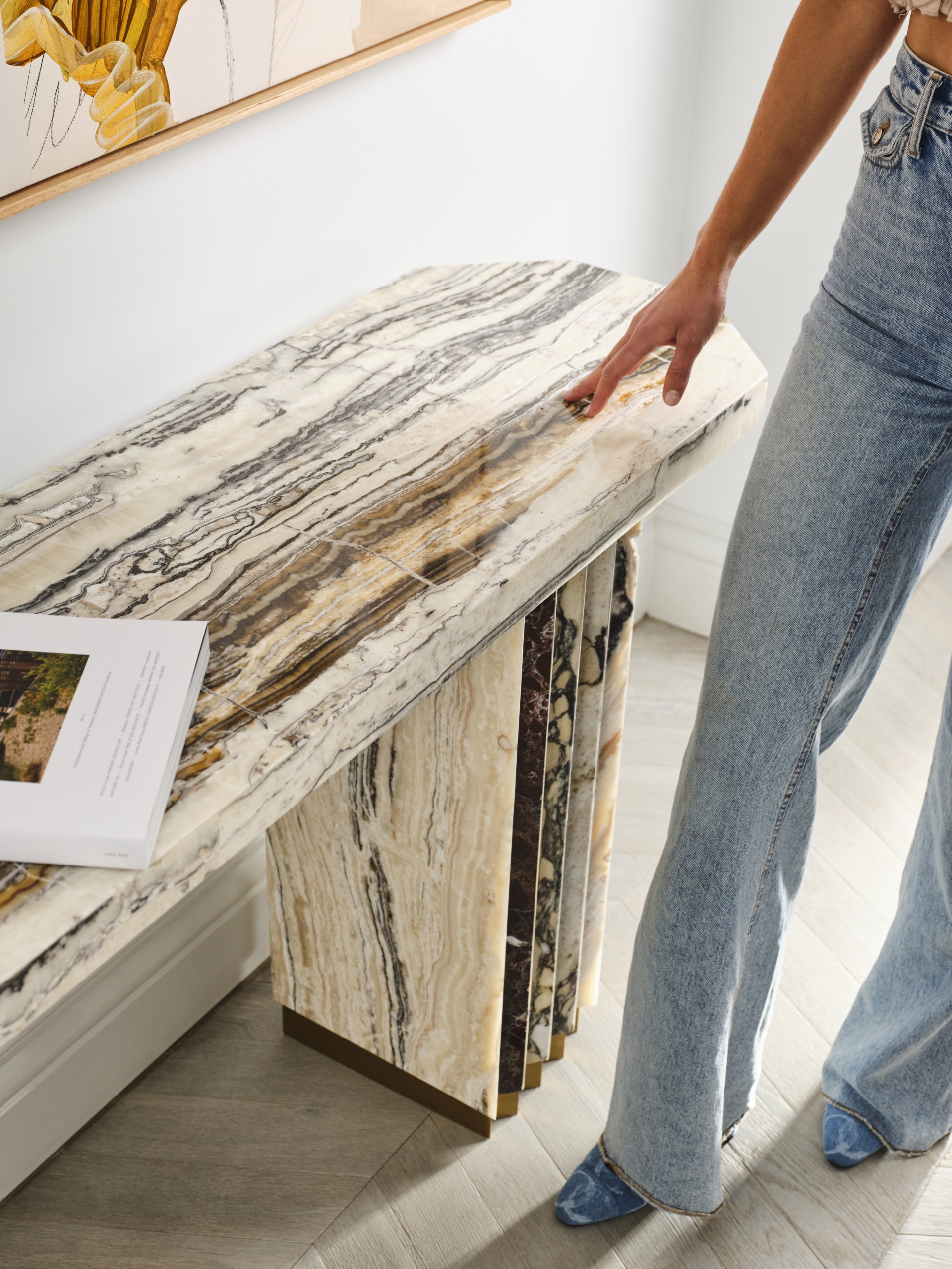 Marble console table with a coffee table book on top.
