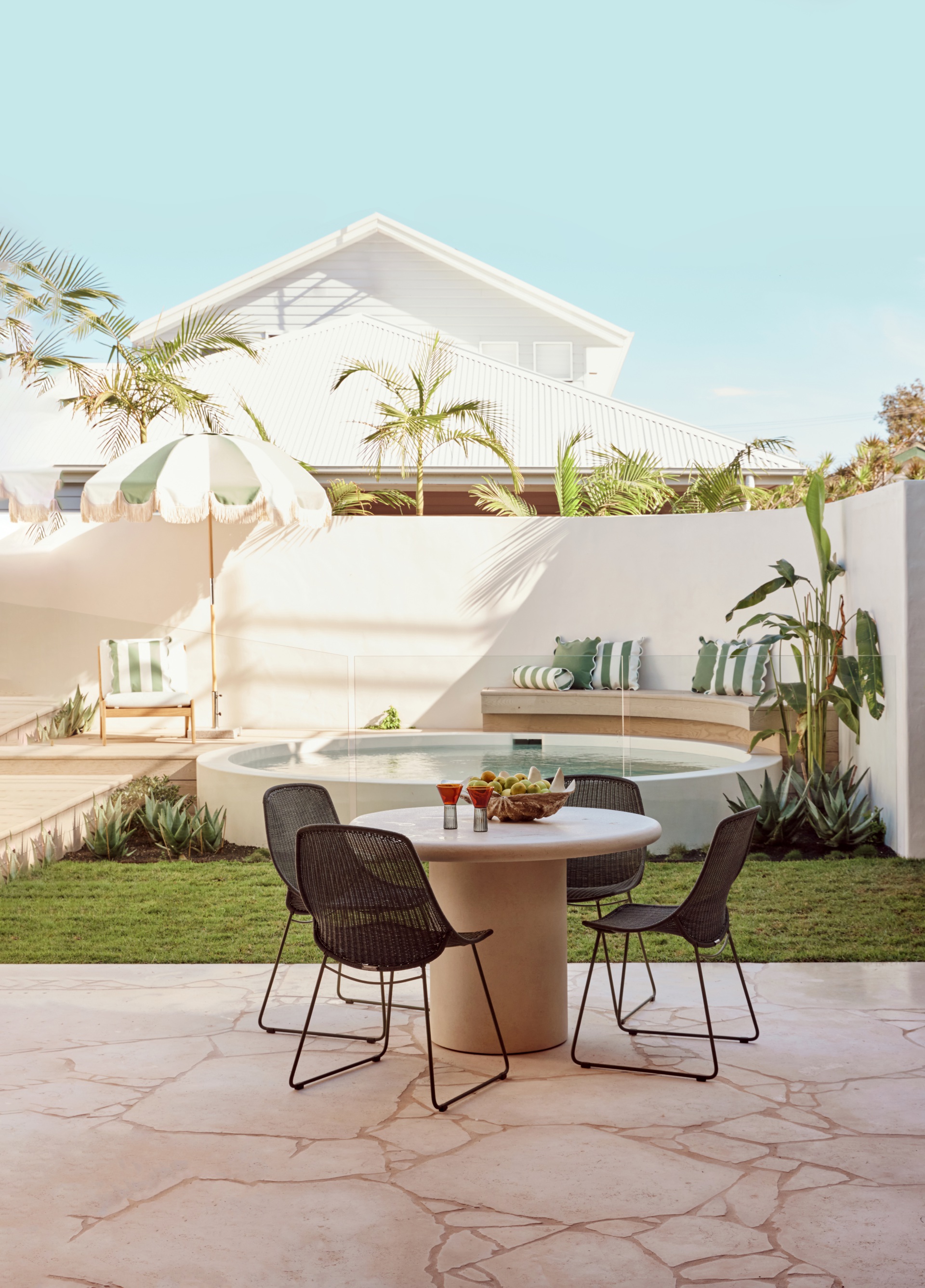An outdoor alfresco area beside a round pool.