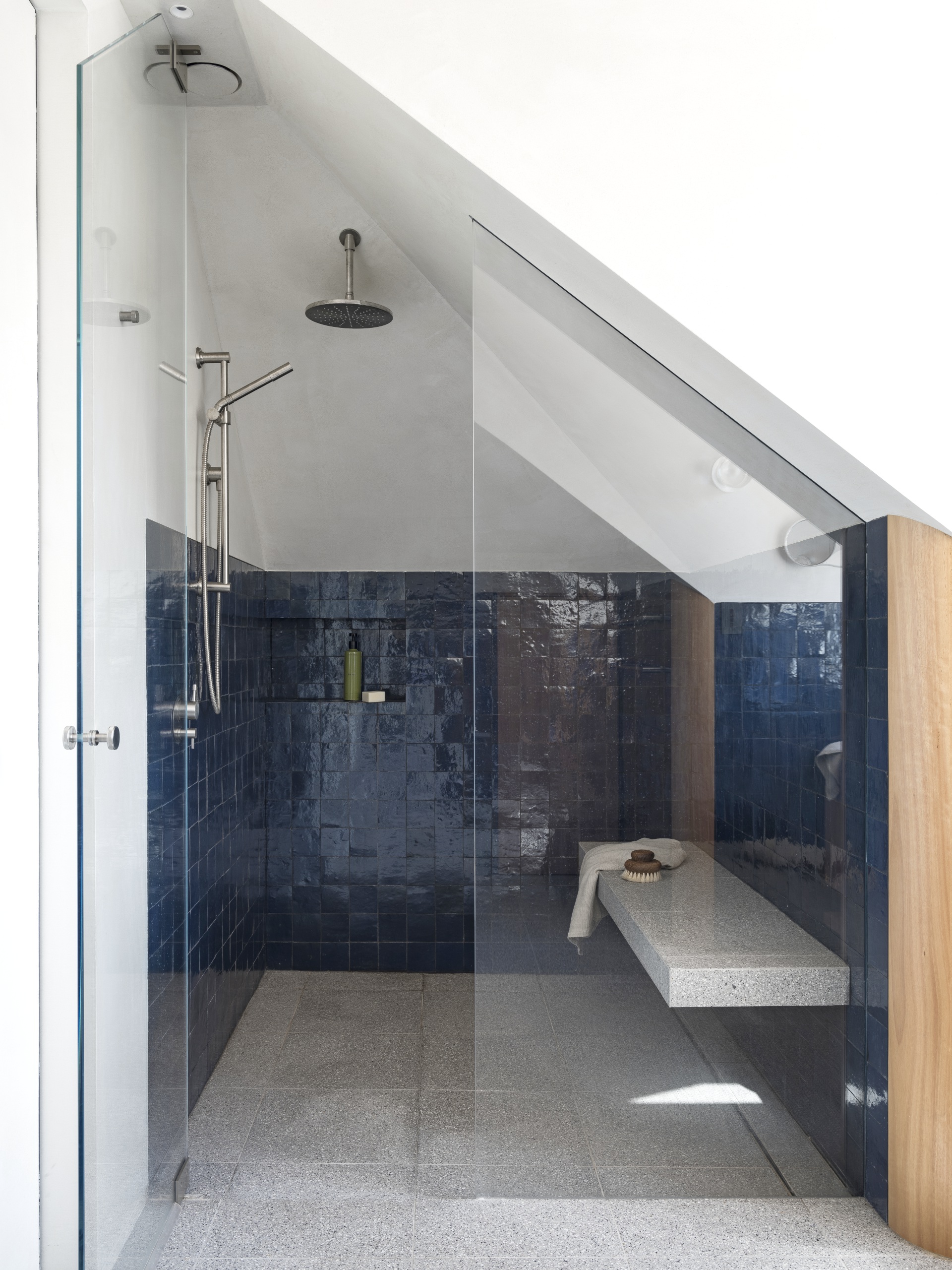 Bathroom shower with a seat. 