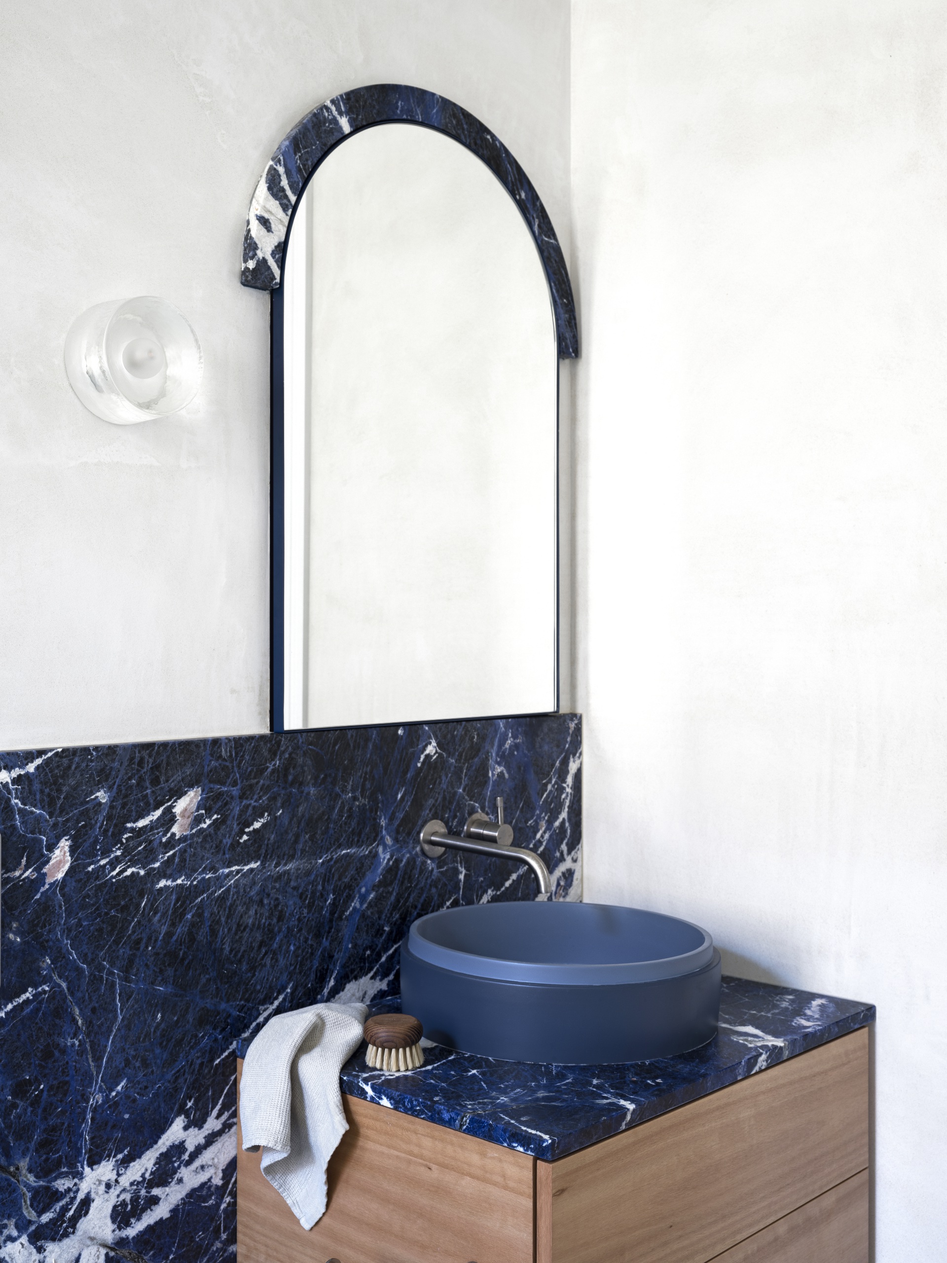 Marble bathroom and blue sink. 