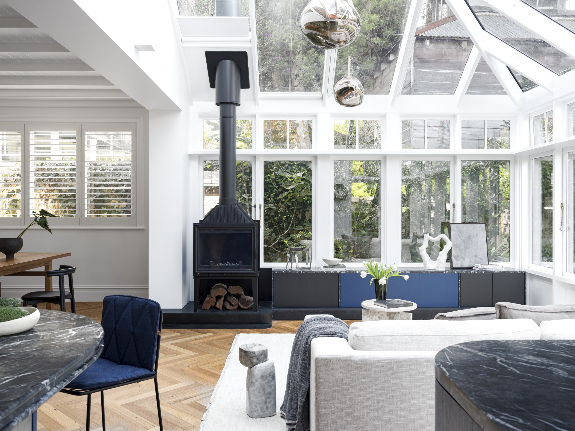 A sun room/conservatory with a fireplace. 