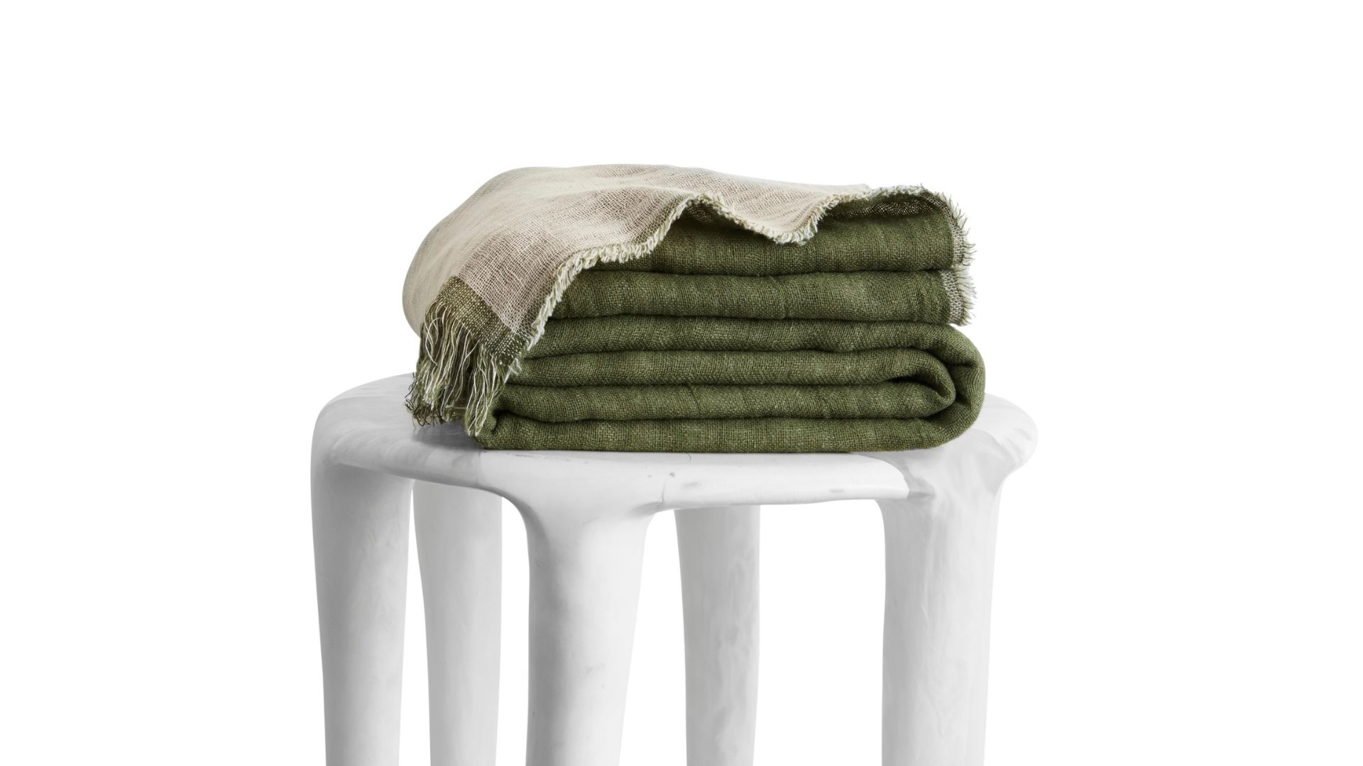 A green and white muslin throw blanket