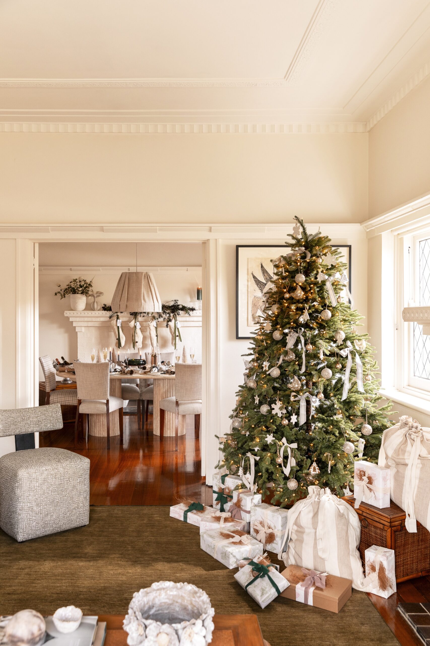 Neutral decorations and pops of green enhance the appeal of this Christmas tree
