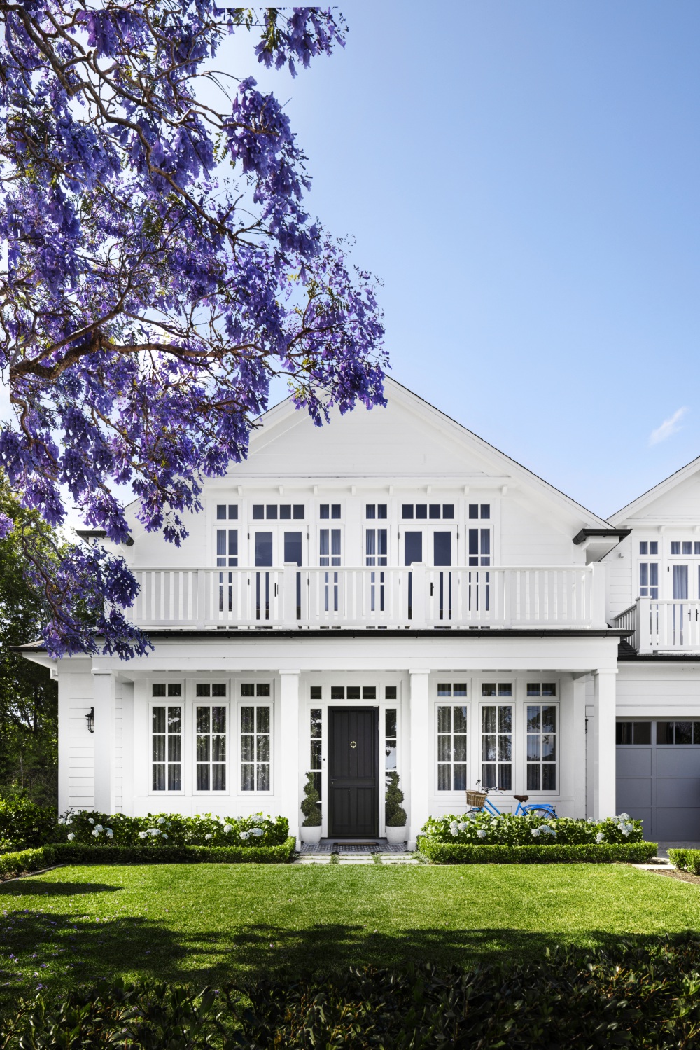 The facade of a white Cape Cod style home on Sydney's lower north shore.