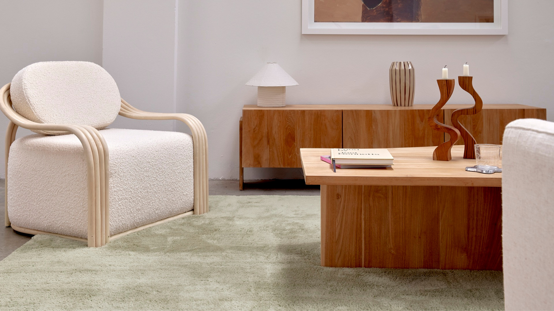 a modern living room with a green carpet ru and wooden furniture