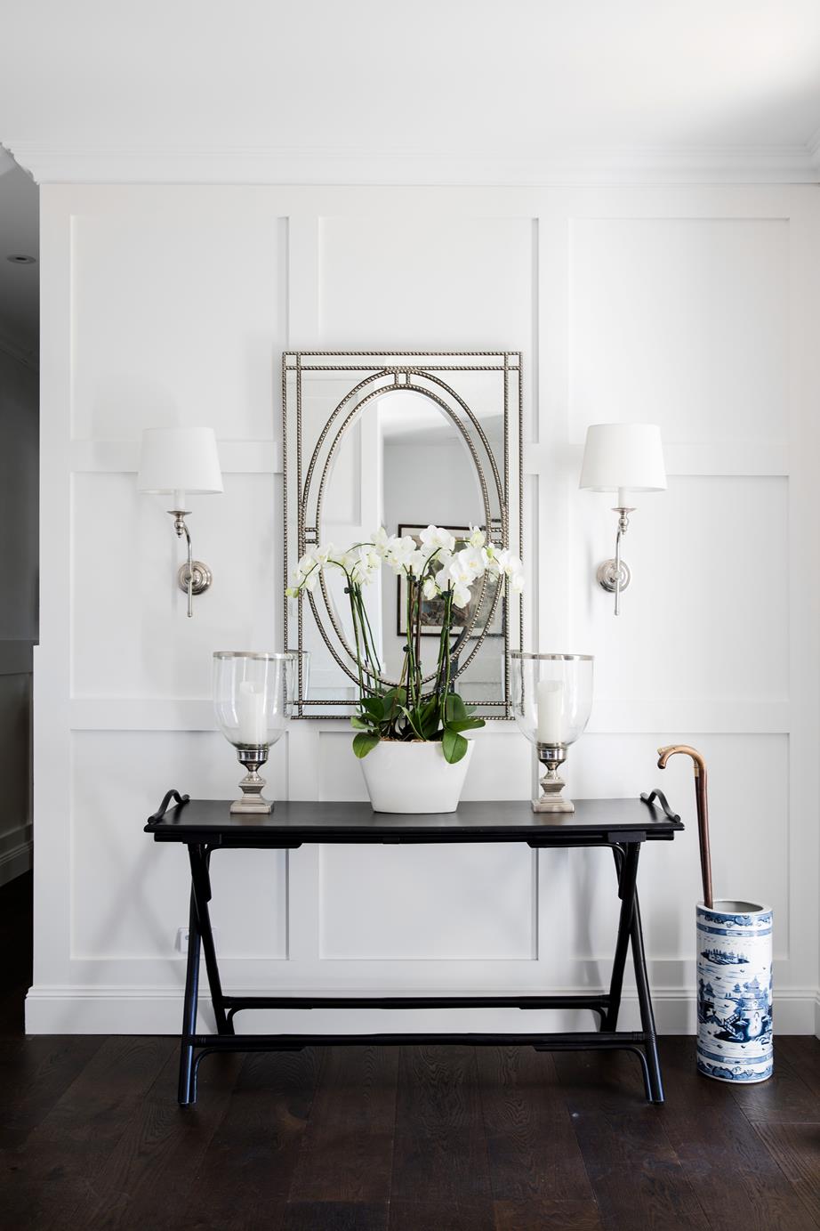 Hamptons style home entrance with console and dark flooring