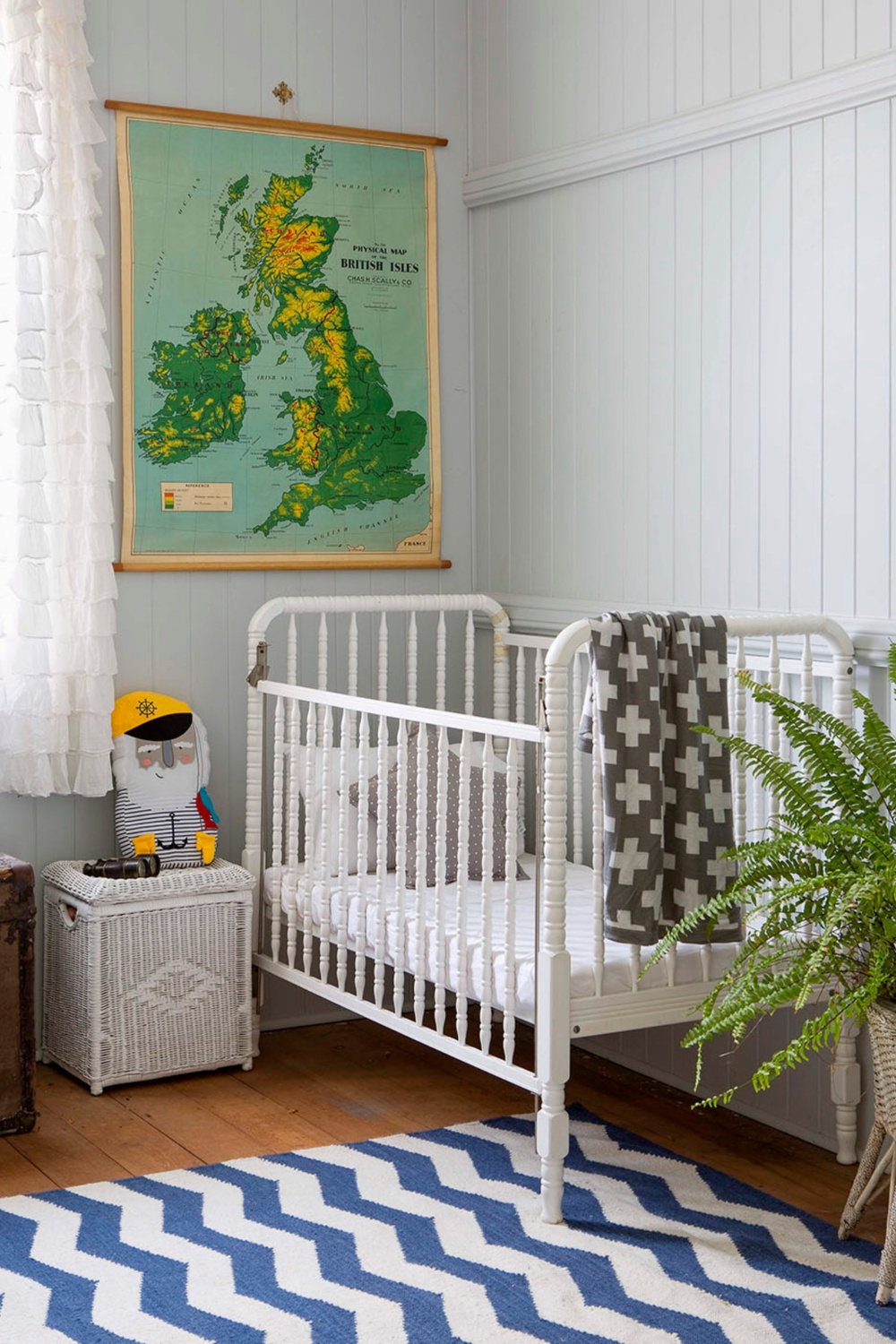 Baby nursery with wicker furniture and Boston fern