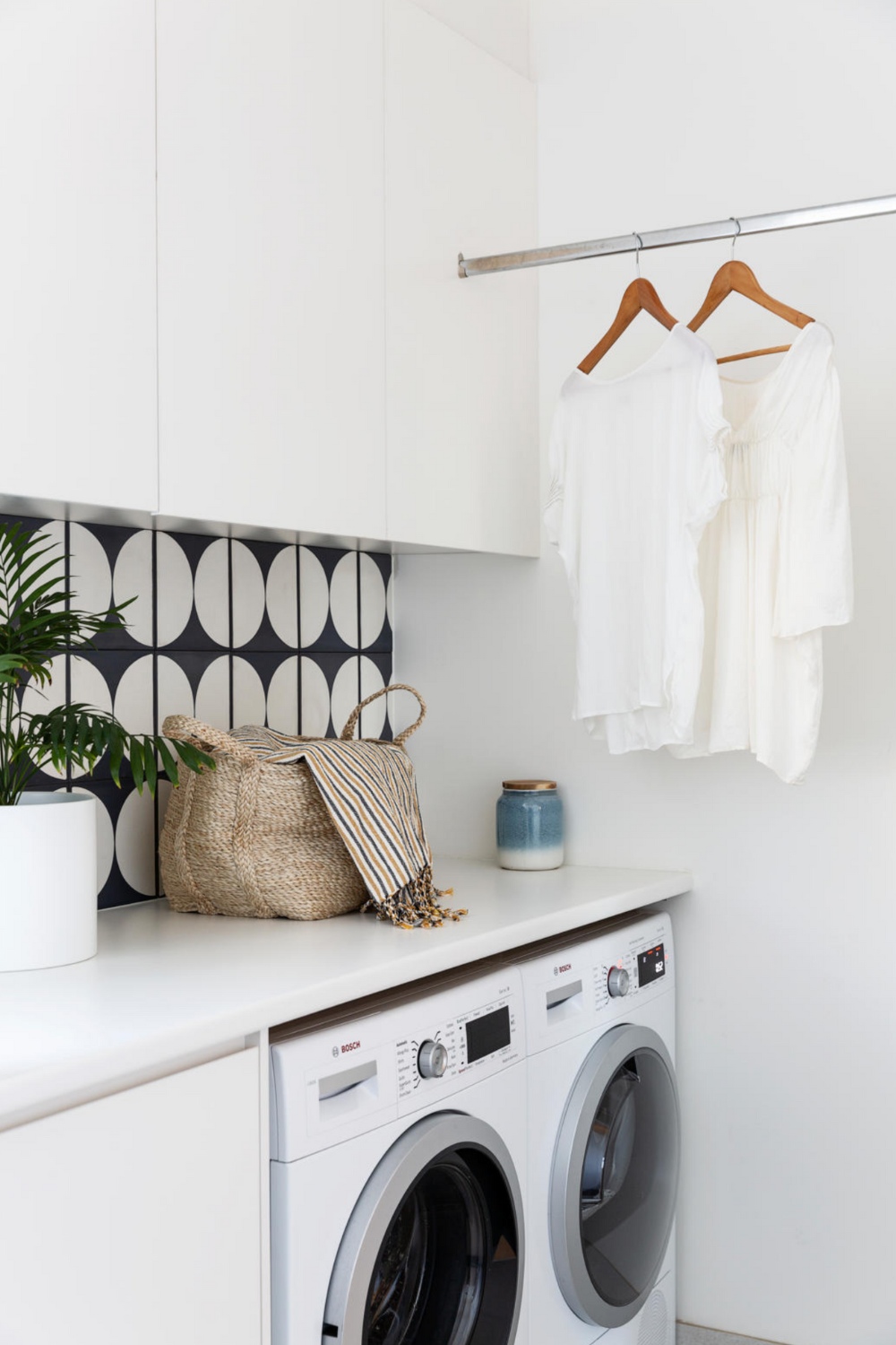 White laundry with t-shirts hung on rail